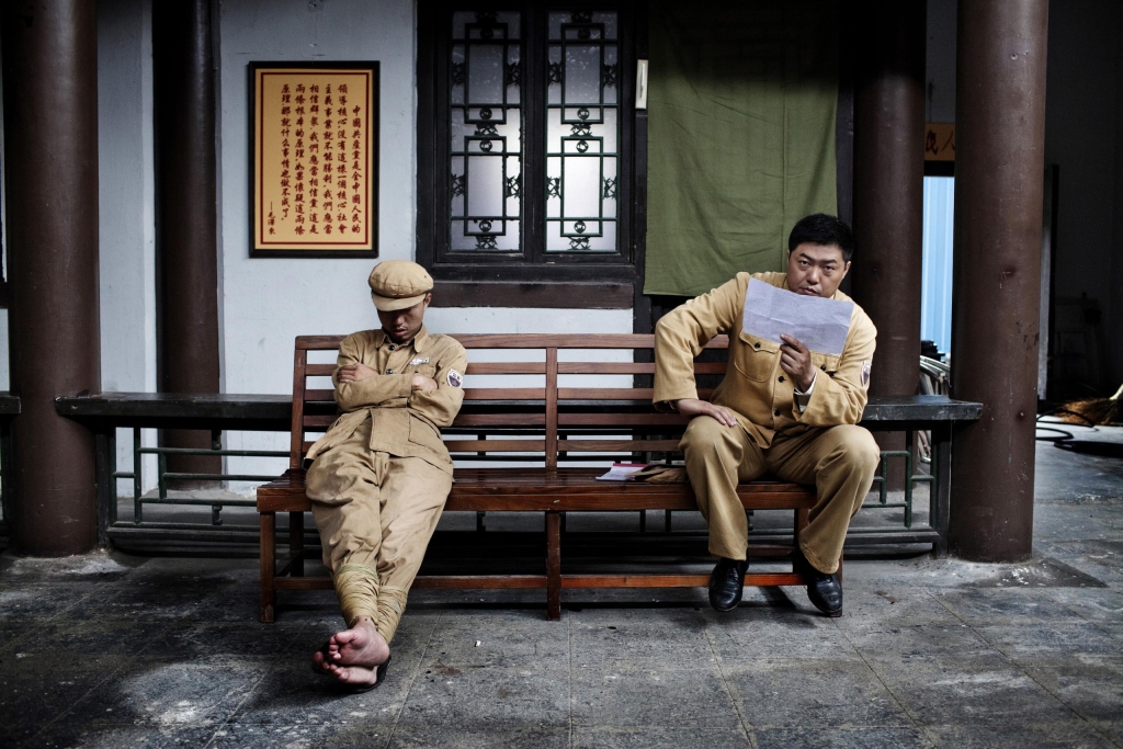 Photo by Giulio Di Sturco Actors prepare for a new scene, at Hengdian World Studios. The studio is the largest in Asia, and houses the largest indoor Buddha in China. The Chinese film industry is booming, and China already forms Hollywood’s largest export market. The Chinese Ministry of Culture and rich local investors see the industry as an instrument of soft power. Films made in China can shape how the country is viewed abroad, as well as uphold traditional values at home. For its part, and in order to circumvent restrictions in China that permit the screening of only 34 foreign films annually, Hollywood has embarked on major co-productions with Chinese studios. In these films, additional characters may be introduced, and scenes tailored, to meet the tastes and censorship requirements of the Chinese market.