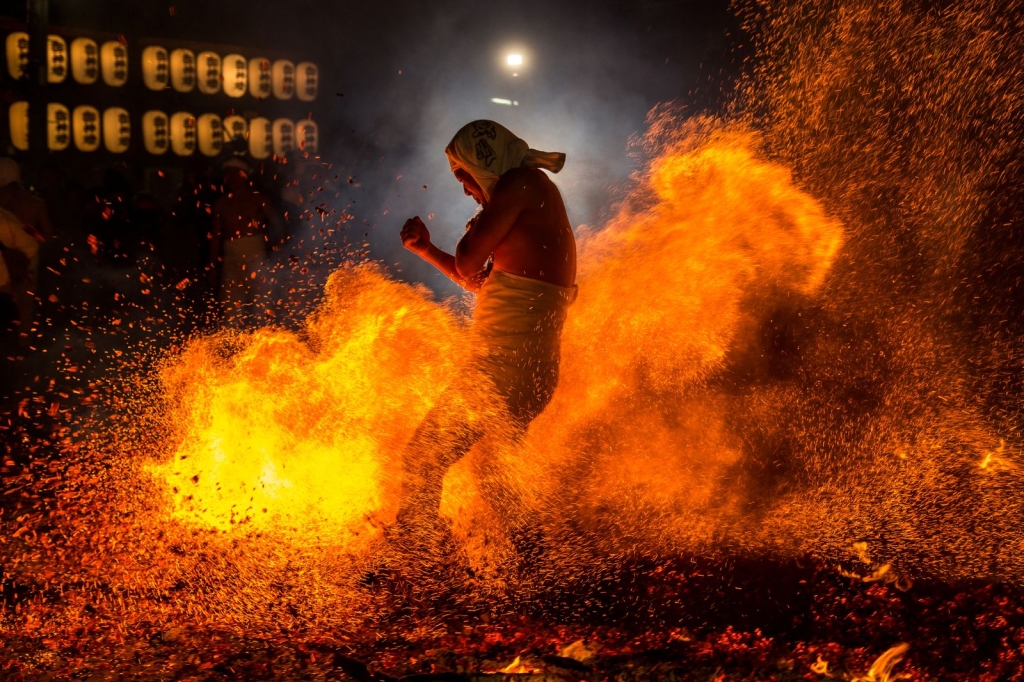 Photo and caption by Hidetoshi Ogata This is the one scene of the fire festival. This festival called "Yassai-Hossai" is founded on a fact that fisherman helped their god "Ebisu" who was drifted on Iwatsuta Shrine. They warmed Ebisu by burning of one hundred eight pieces of fire wood bundles.